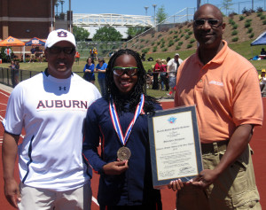 Auburn University sprinter Sheniqua Ferguson (middle) accepts the Academy's 2010 Athlete of the Year Award from Dr. Fred Cromartie, the Academy's Dean of Academic Affairs, (left) as head track and field coach Ralph Spry looks on. The award presentation occurred at the War Eagle Invitational on Saturday, April 16 at Auburn University.